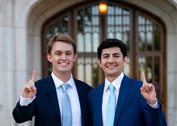 SGA President and Vice President, Caden Glasscock and Cyrus Mortazavi smiling and putting up their index finger for OU.