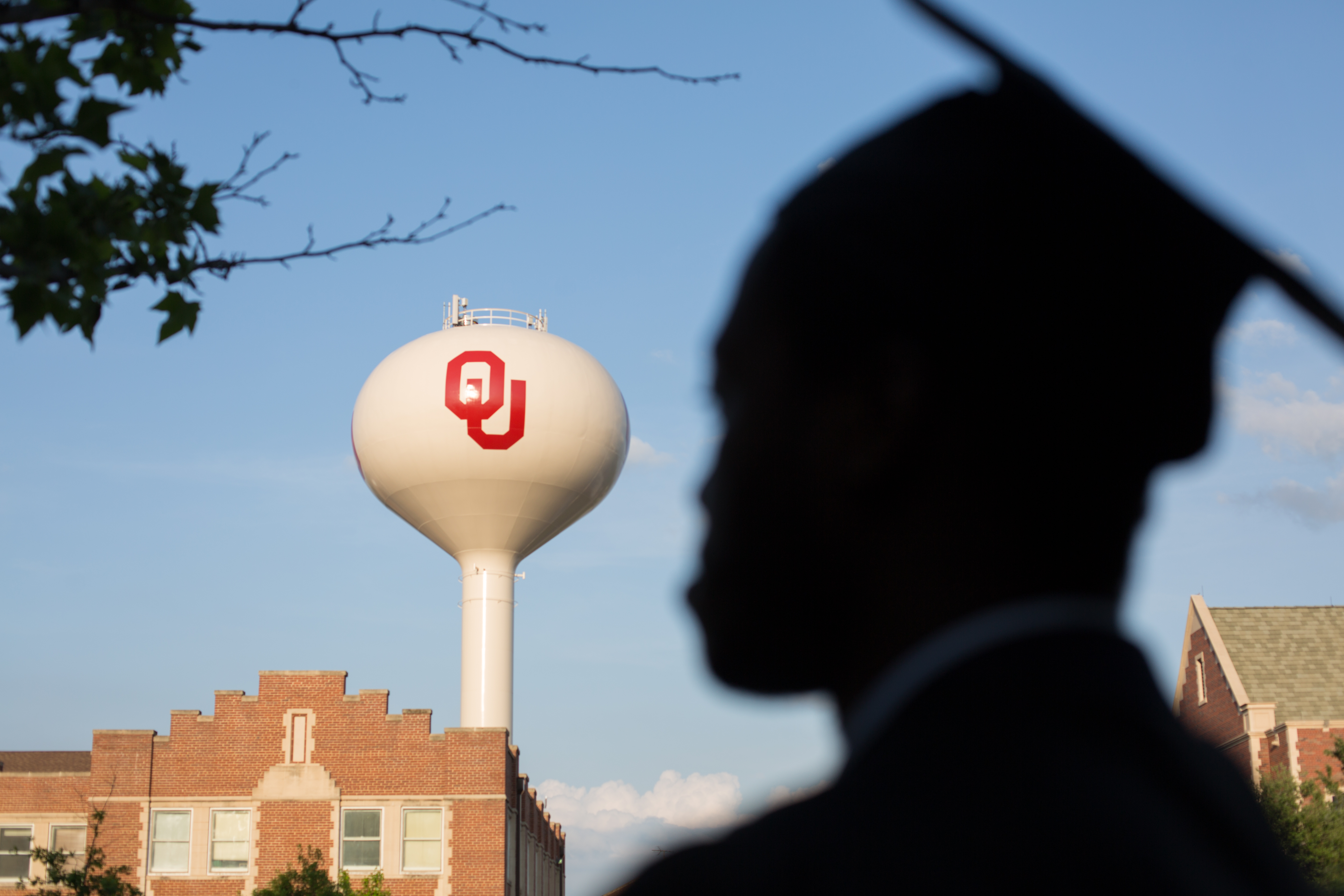 Student with cap by OU water tower
