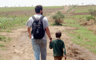 Water Center Student walks with boy in Uganda,OLYMPUS DIGITAL CAMERA