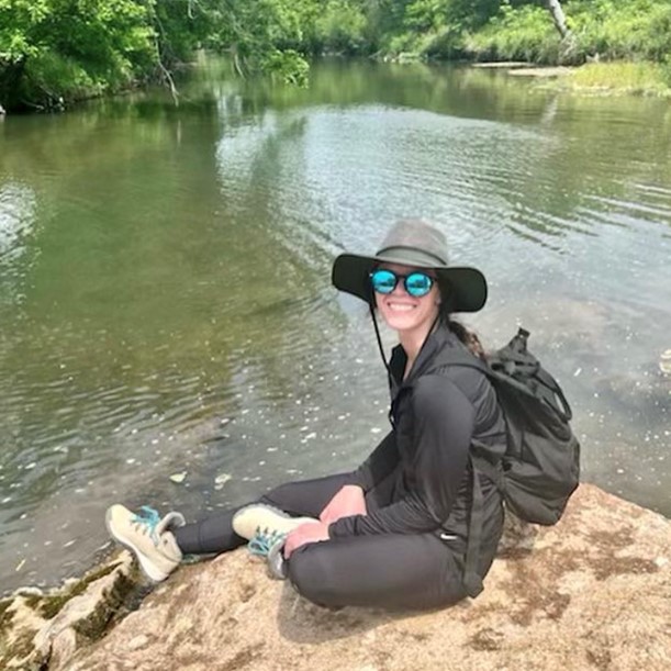 Photo of student taking samples at a water source