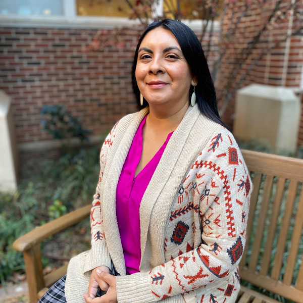 A white placeholder silhouette set against a crimson background.