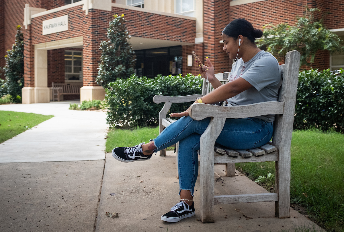 Four students in front of Kaufman Hall 