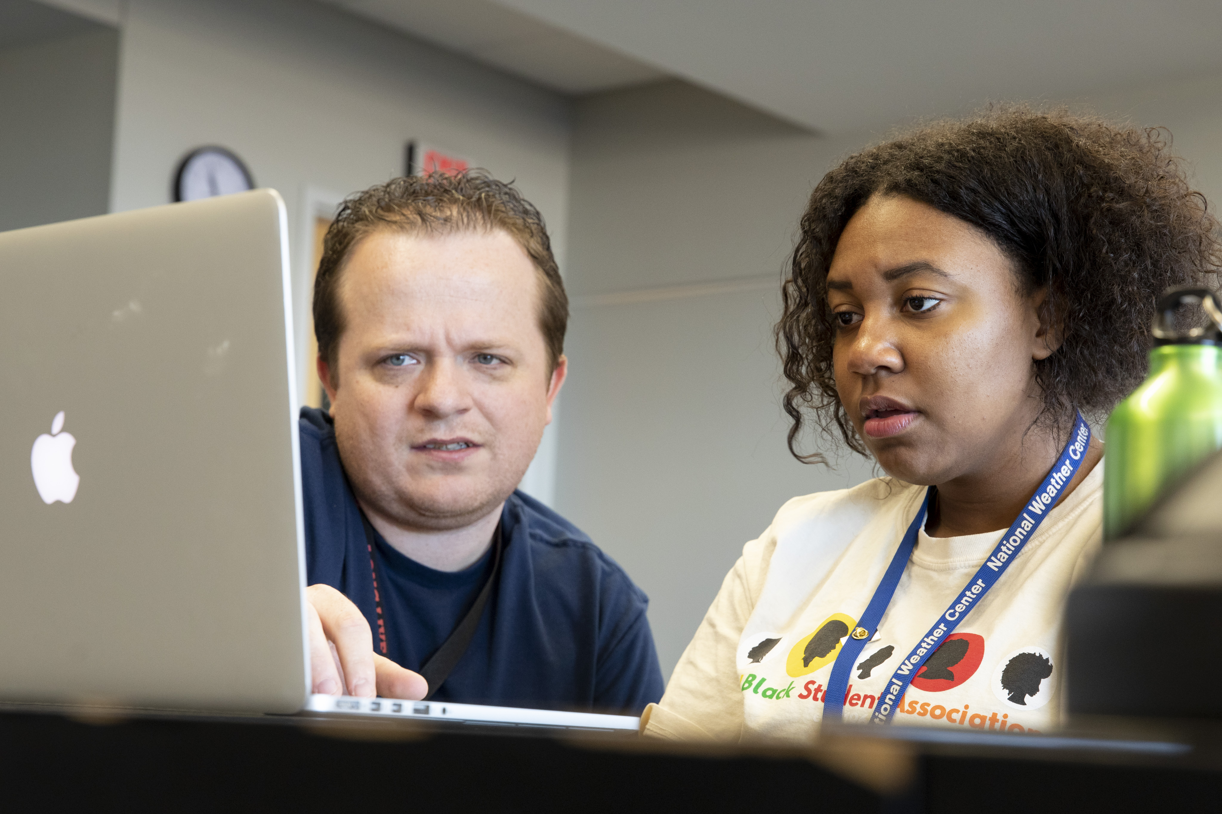 An IT professional profides laptop support to a student