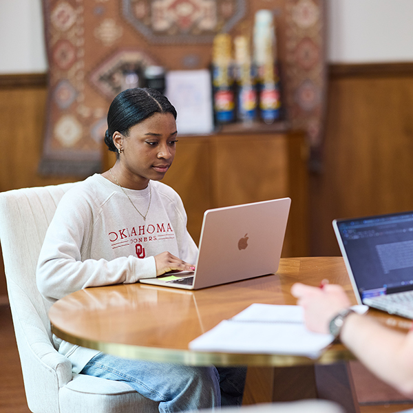 Student working on laptop at table