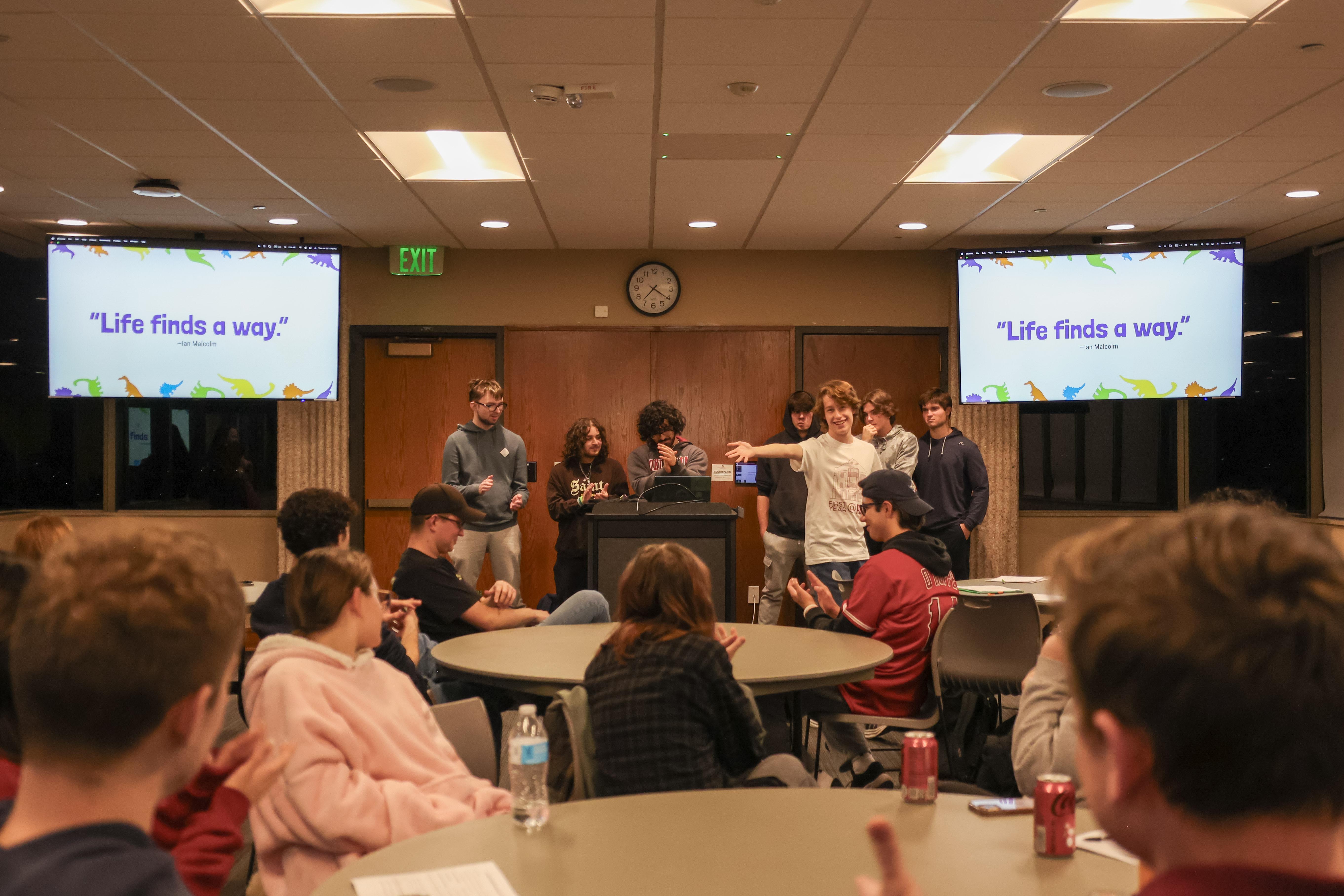 Student lecturing in front of the classroom. 