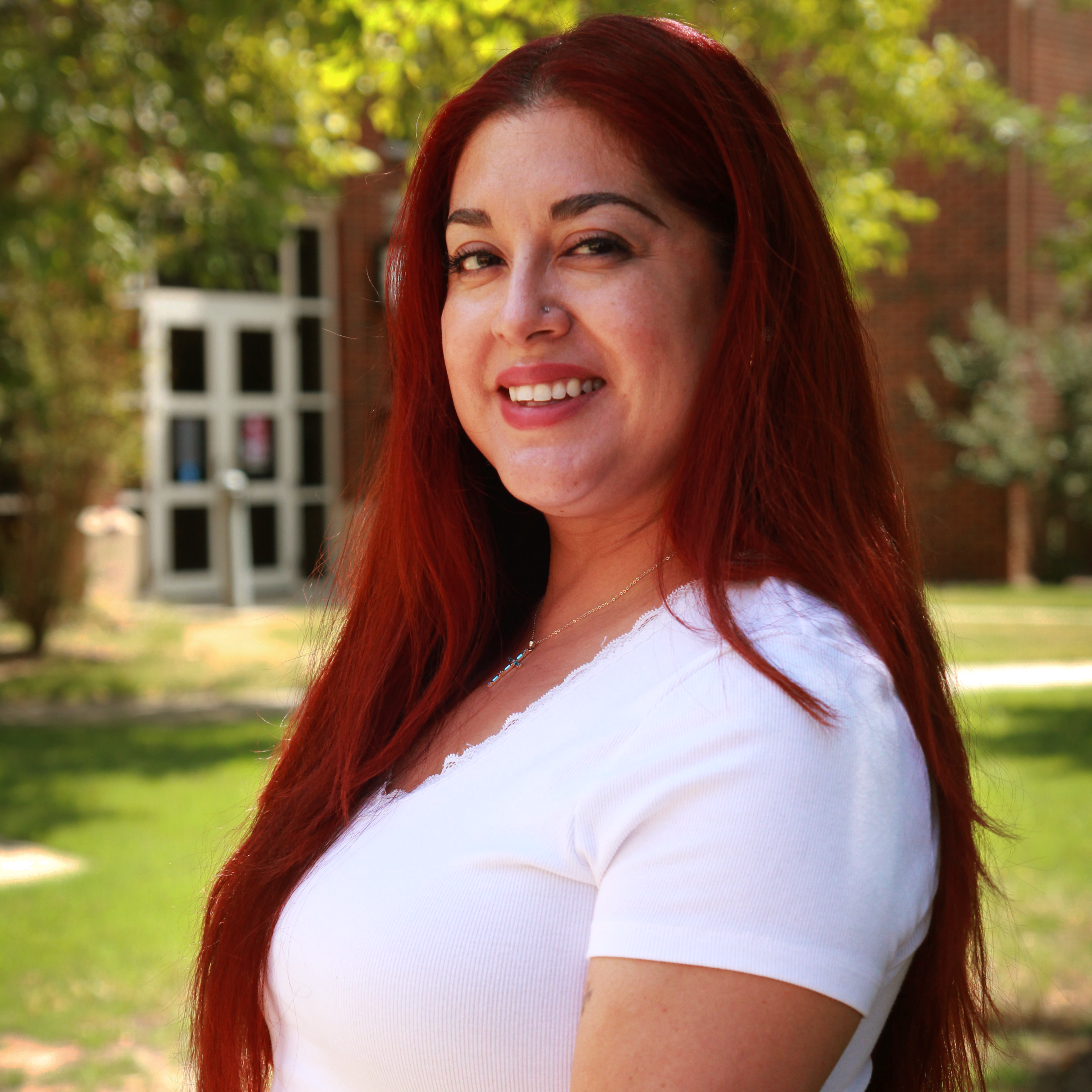 A person silhouette icon in white over a crimson background.