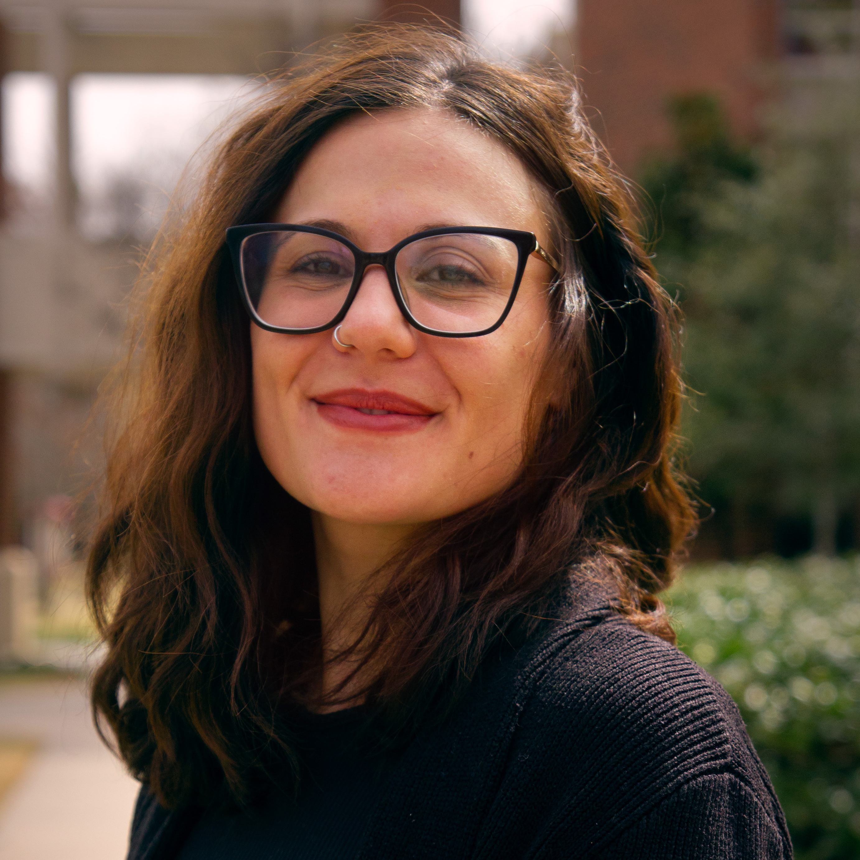 A person silhouette icon in white over a crimson background.
