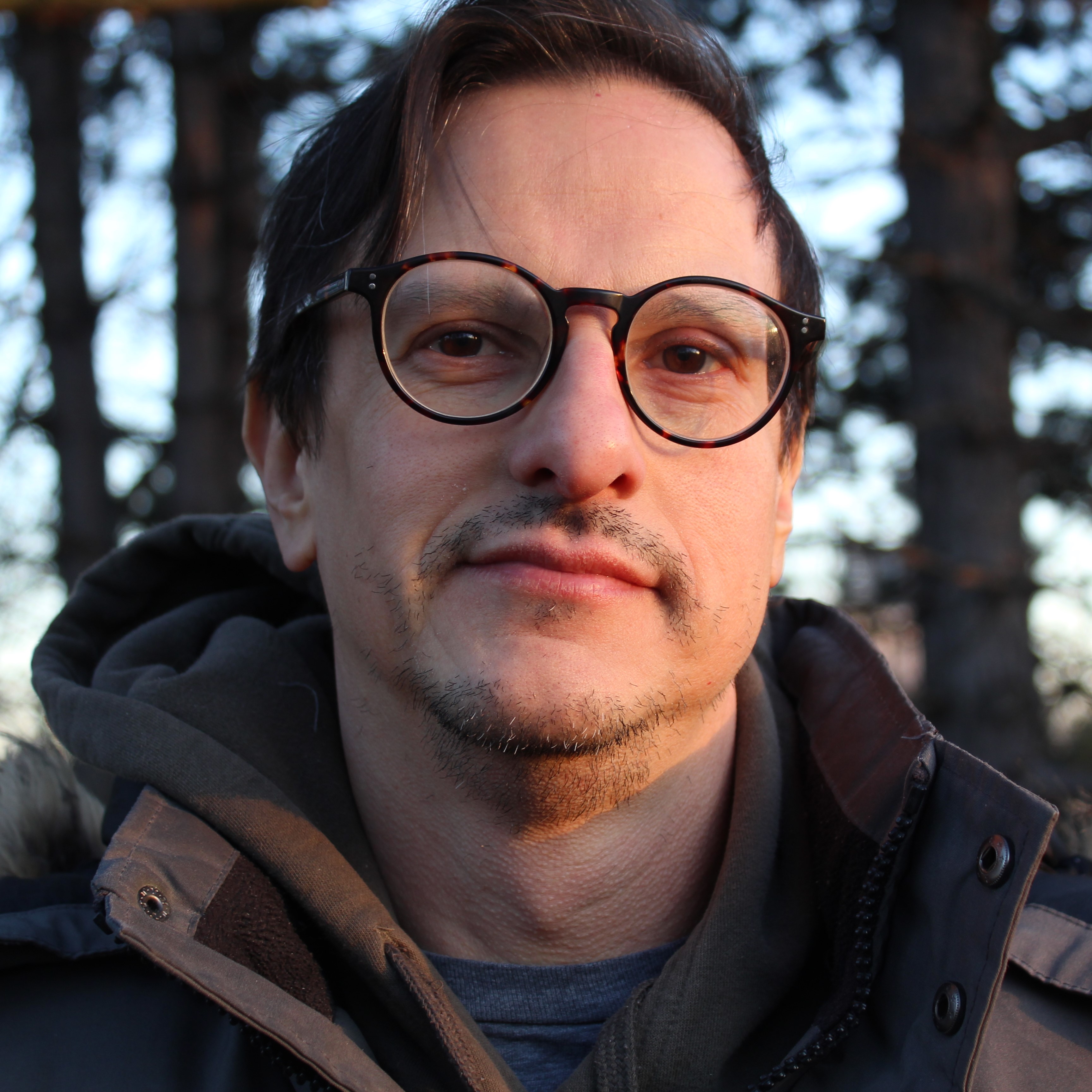 A person silhouette icon in white over a crimson background.