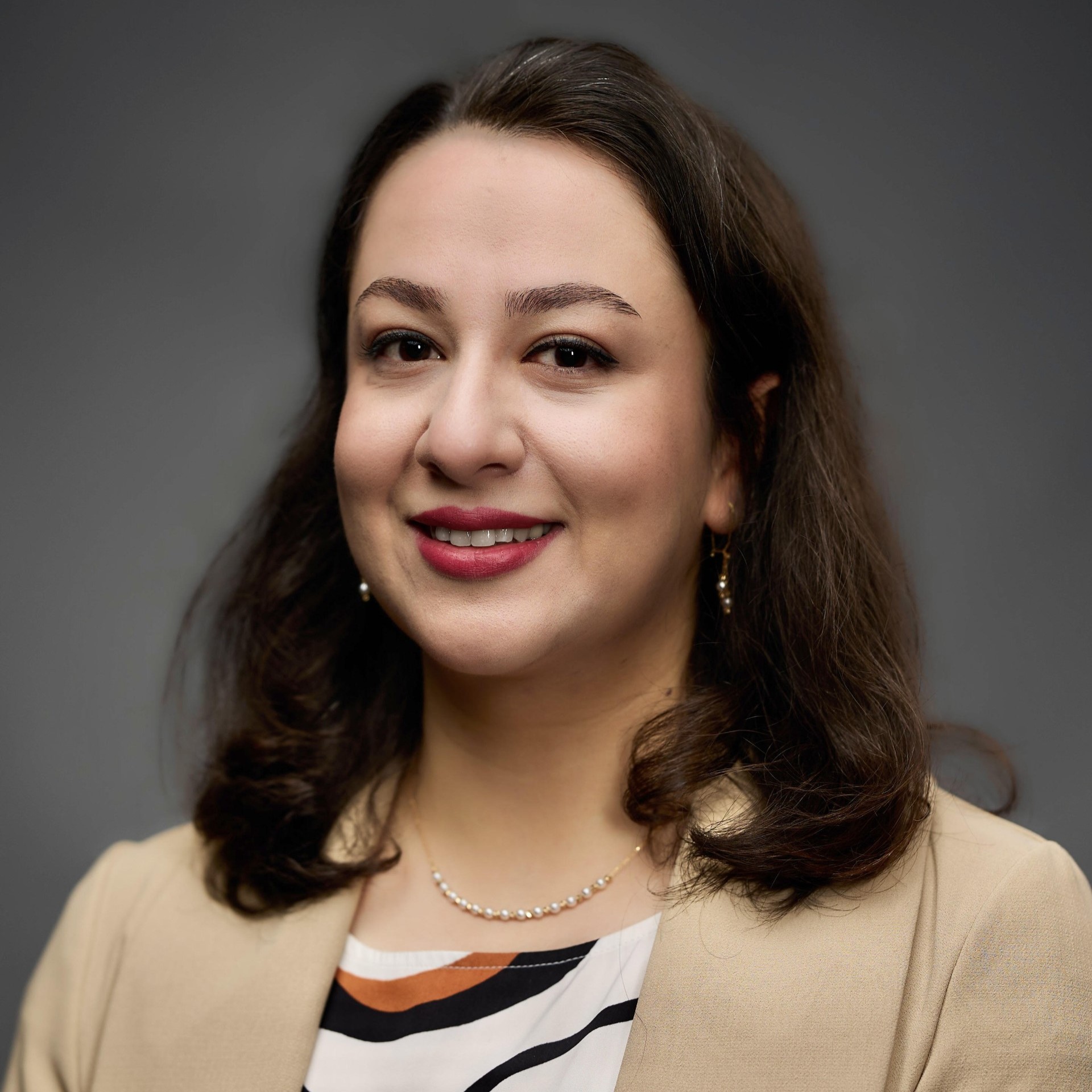 A person silhouette icon in white over a crimson background.