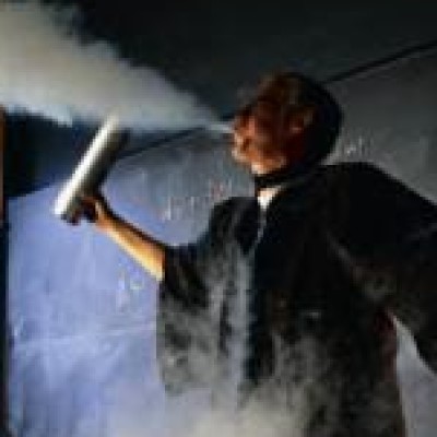 A photo of Stewart Ryan performing a physics demonstration in class.