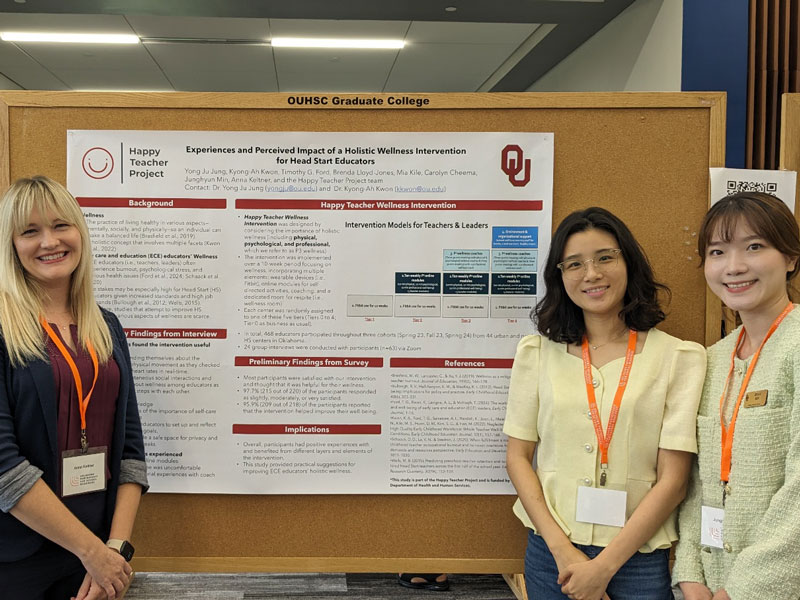 Three faculty members posing with a conference poster.