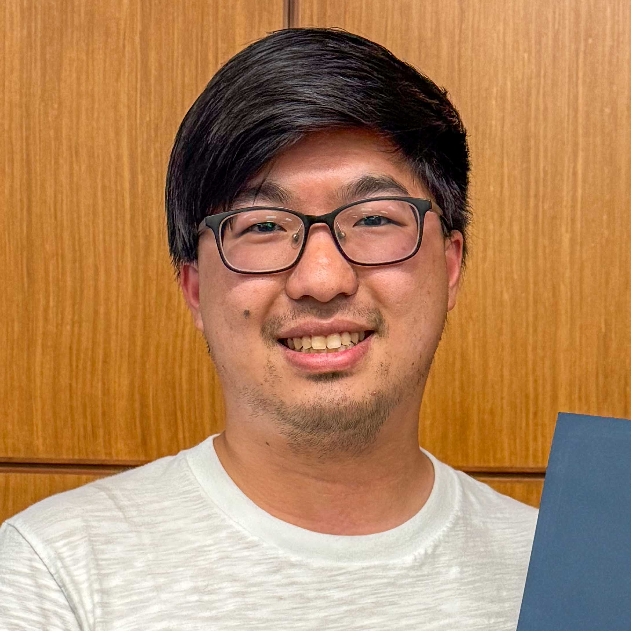 A student holding a certificate.