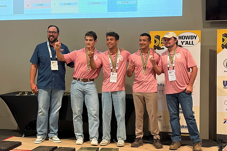 O U students on stage at Asphalt Road competition accepting their award. 