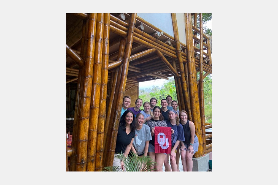Sooners without borders students in Ecuador pose in a bamboo hut. 