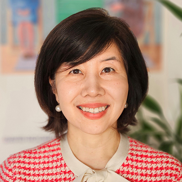Kyong-Ah Kwon, woman with brown hair in red and tan blouse