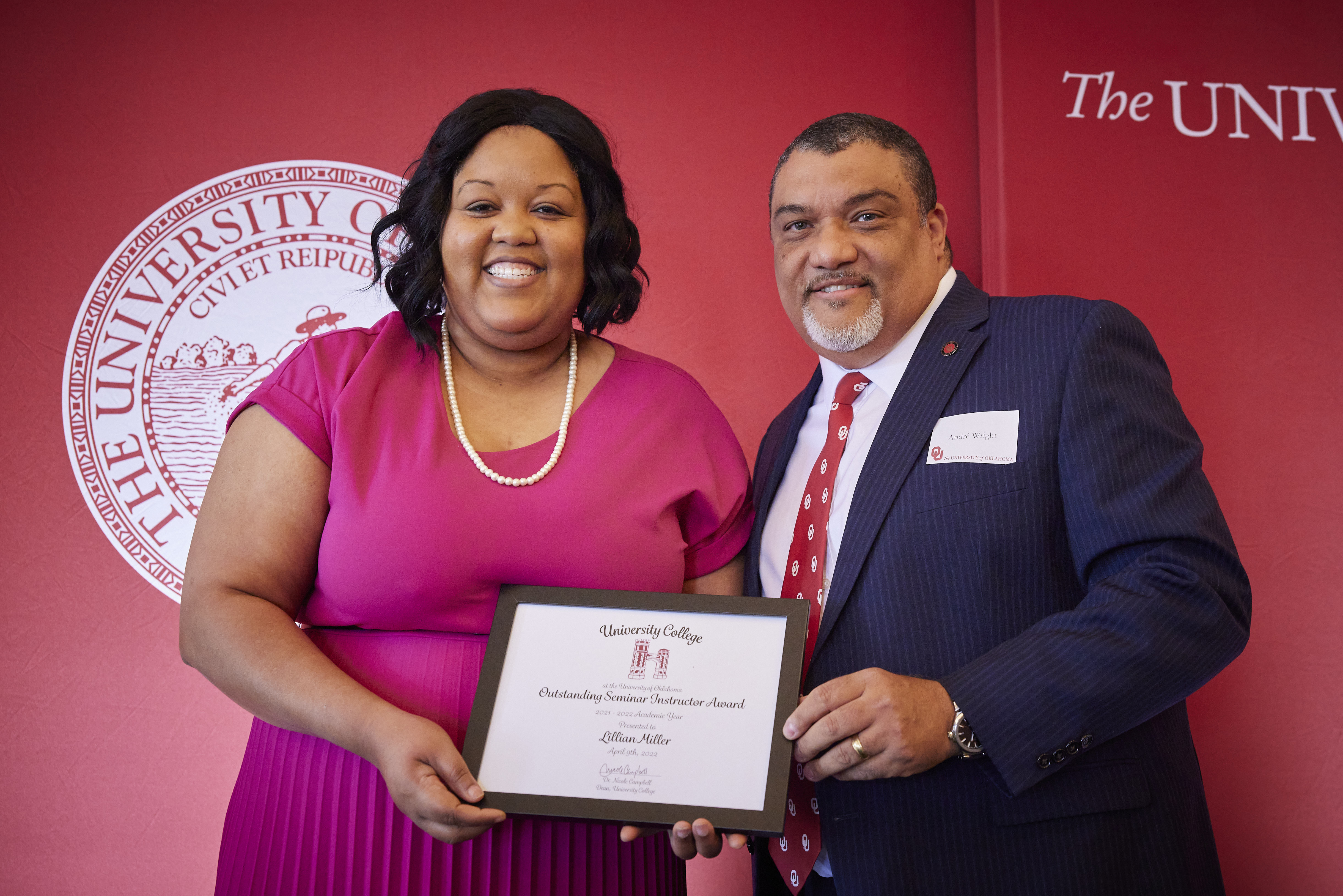 Lillian Miller standing with Provost Wright holding a plaque