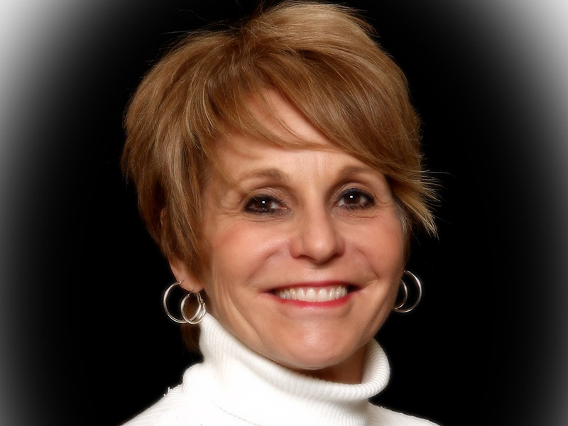 headshot of Courtney Vaughn in a white turtleneck