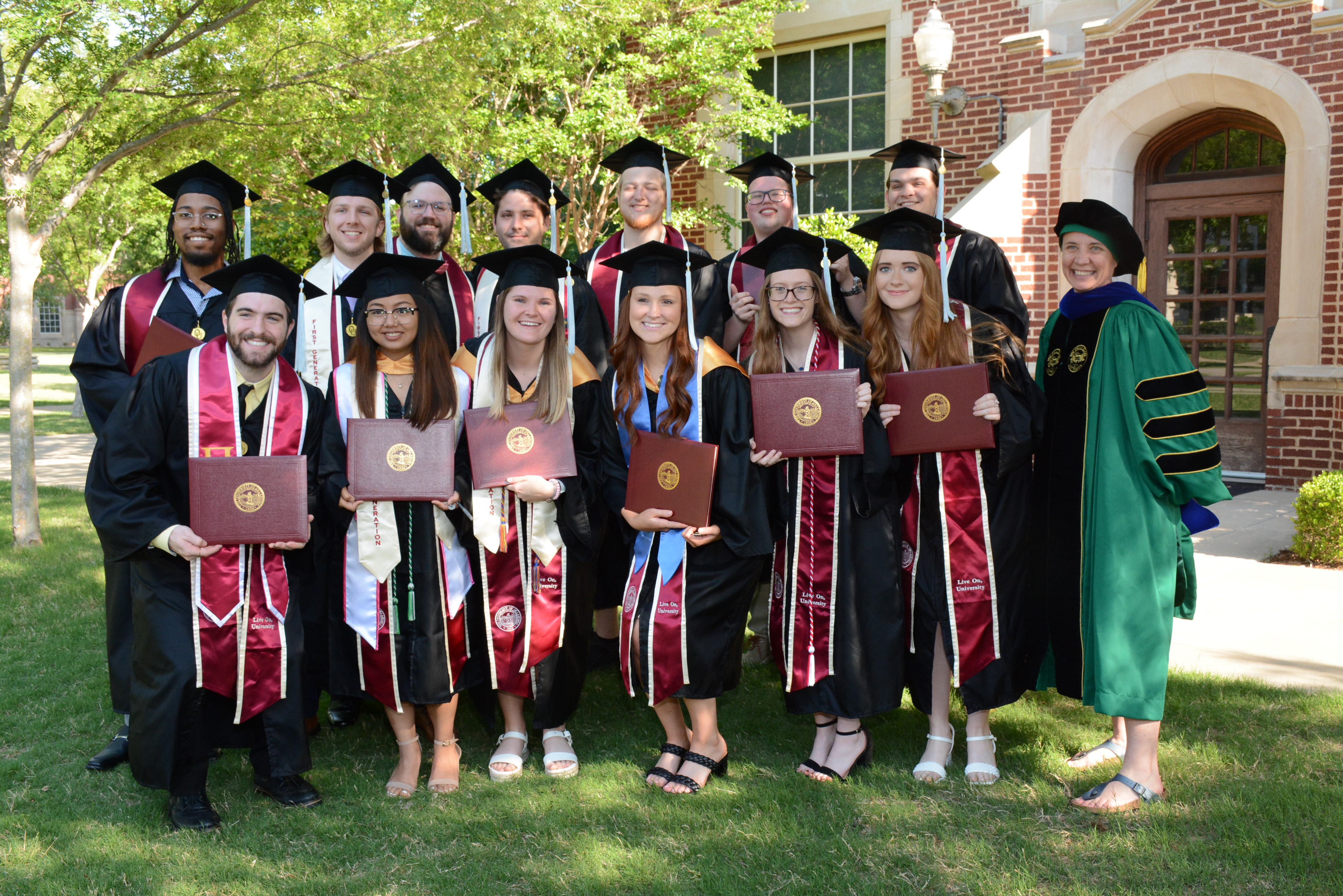 picture of graduates standing together in a group outside