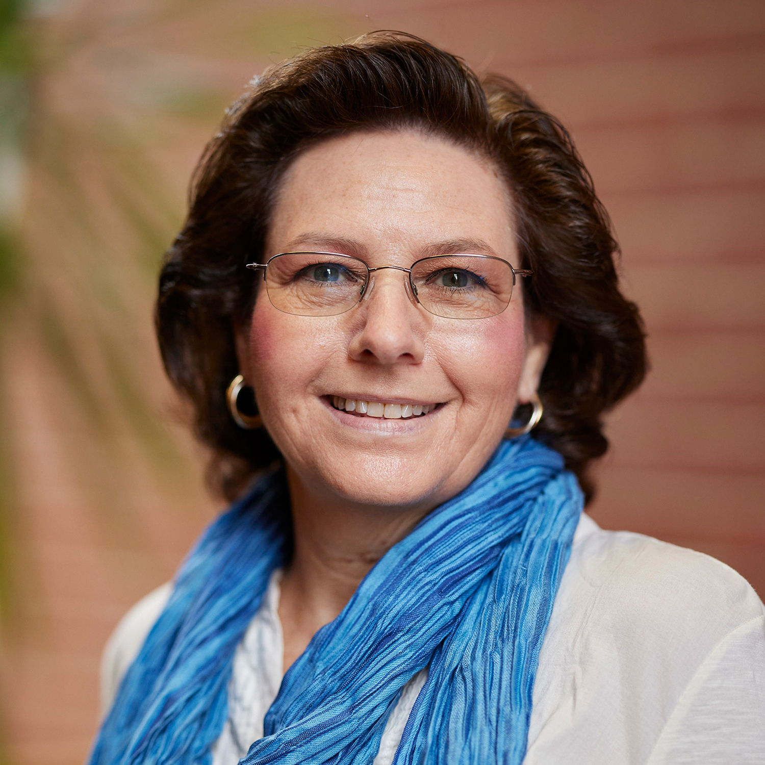 Sherry Cox in a white shirt with a blue scarf