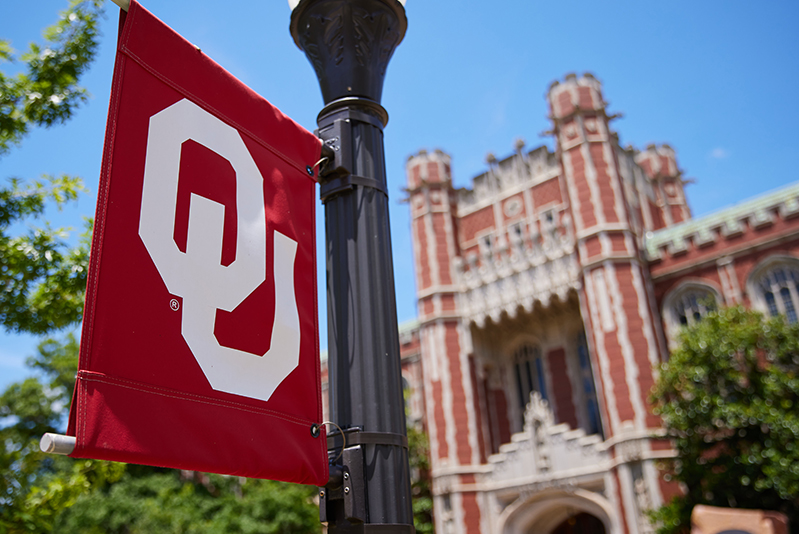 OU flag in front of campus building