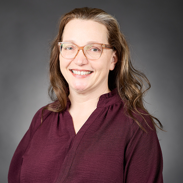 Image of a woman in a burgandy blouse