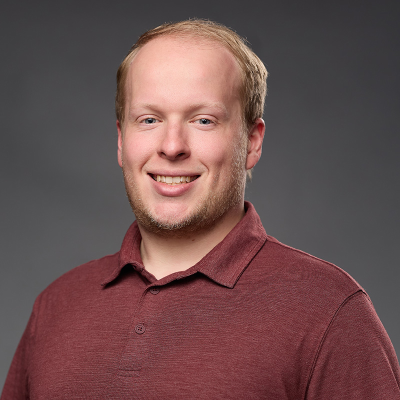 picture of a man in a burgundy shirt