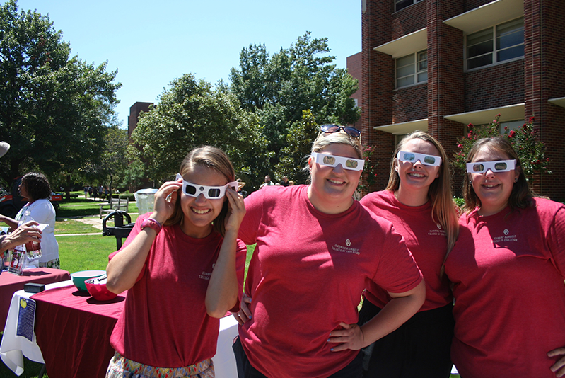 Students outside wearing glasses at solar eclipse event