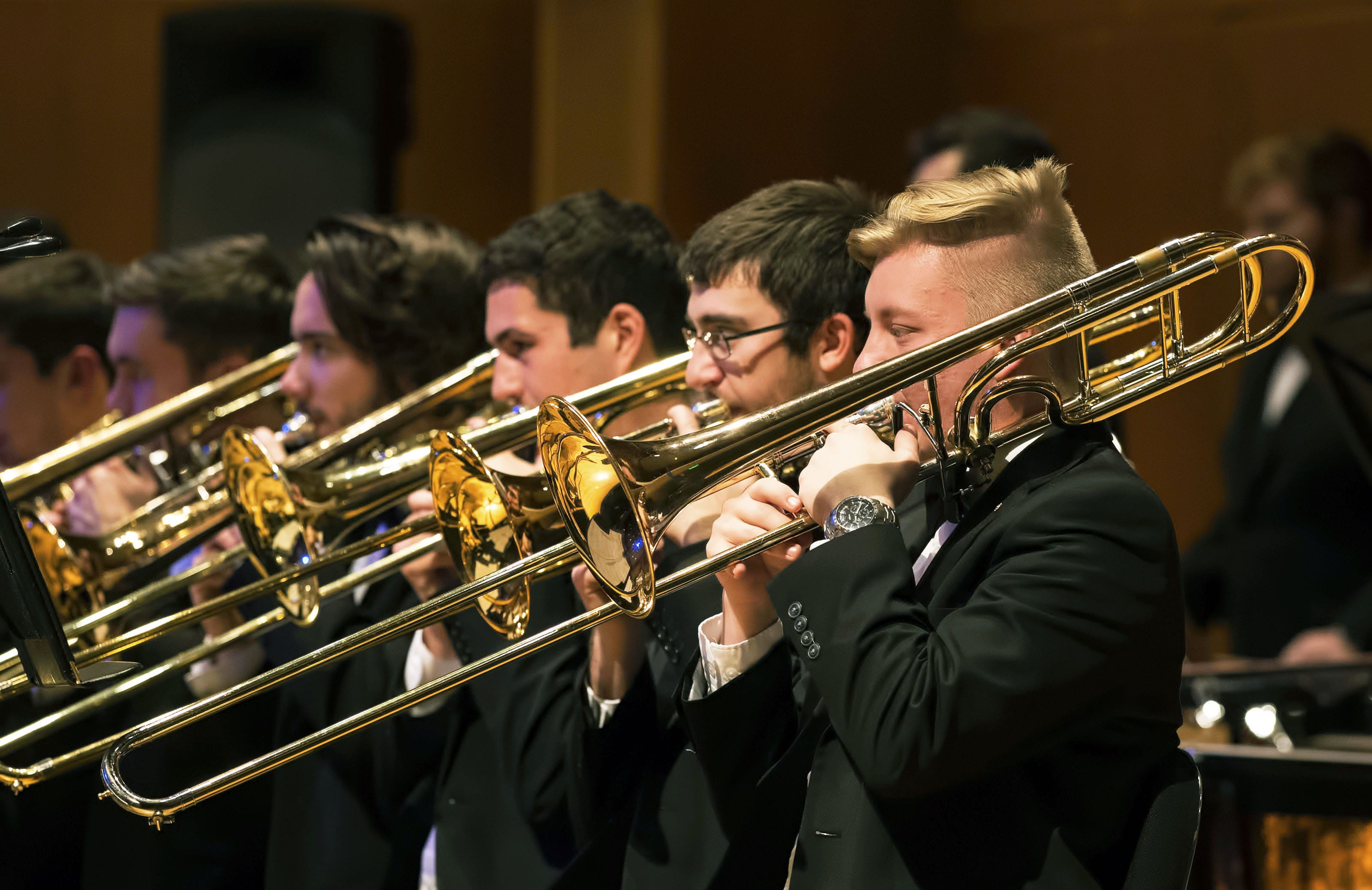 Close up of trombone section in Sharp Hall during OU Concert Band performance.