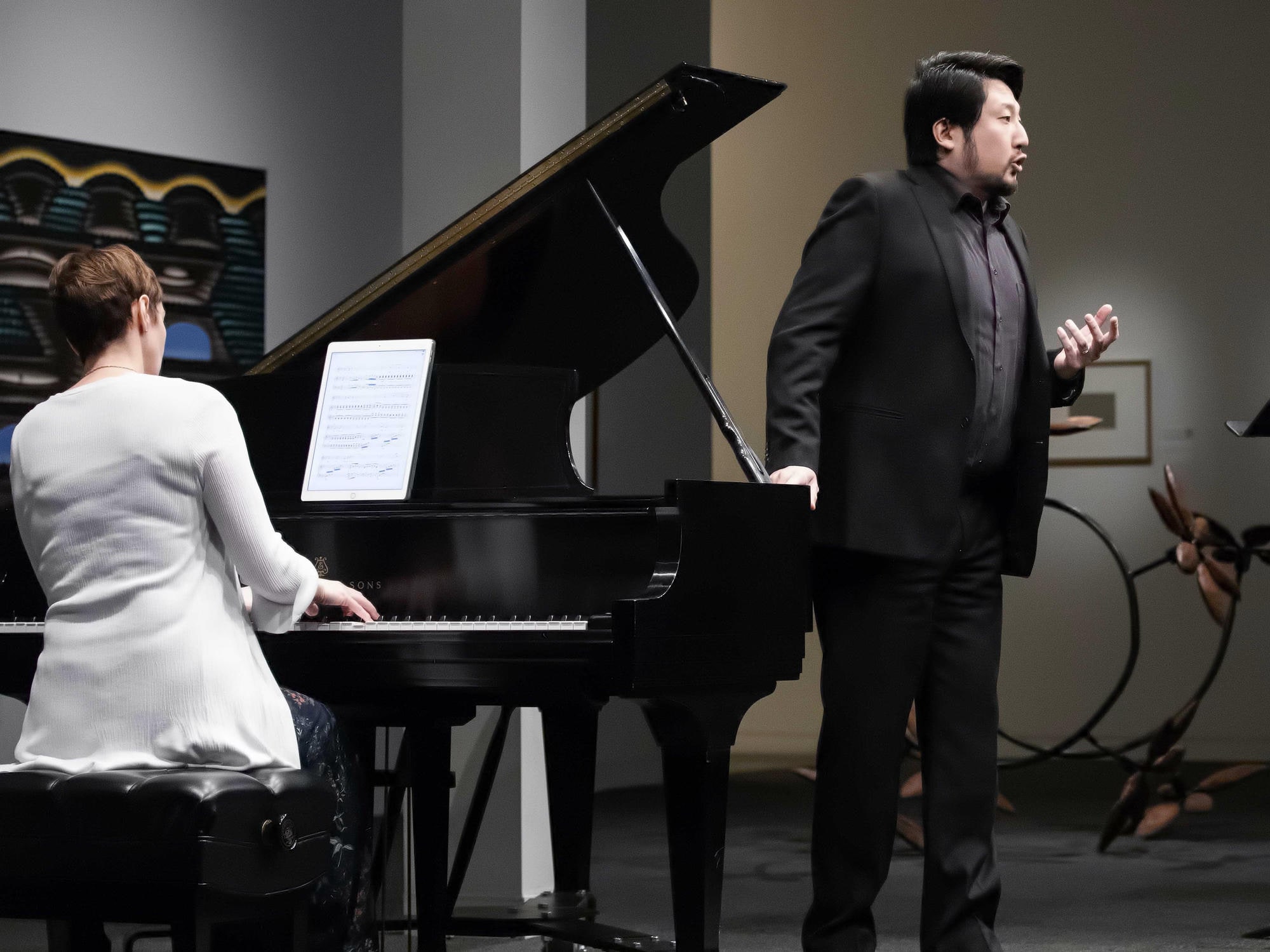 Voice student solo performance with piano accompaniment in Fred Jones Art Museum.