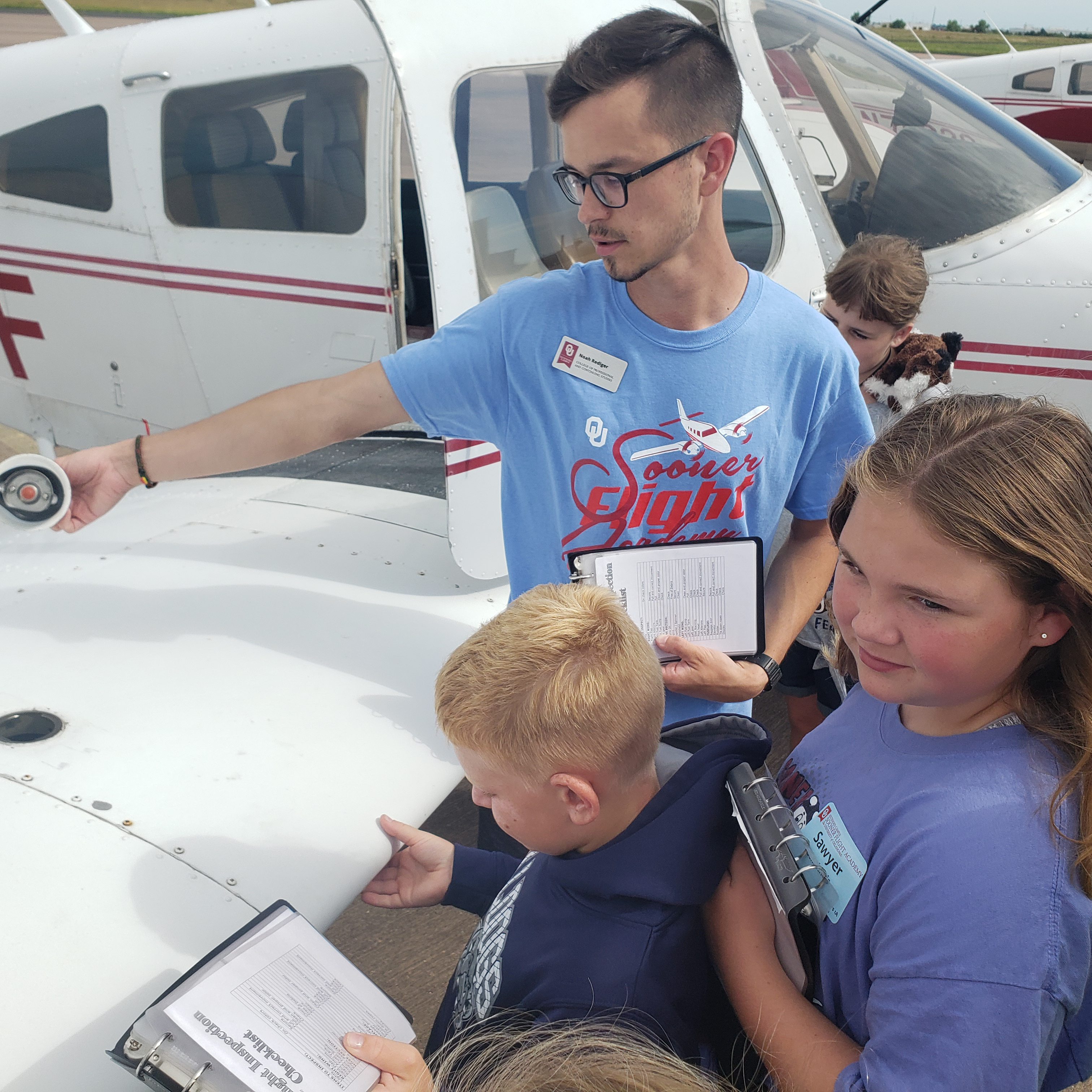 A group of children participate in a pre-flight activity