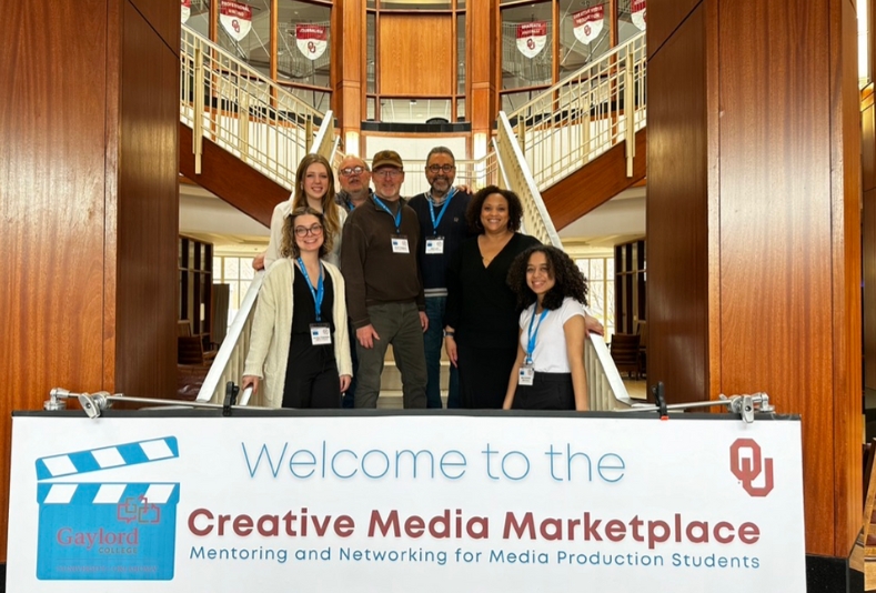 Students and Faculty standing in front of a welcome sign.