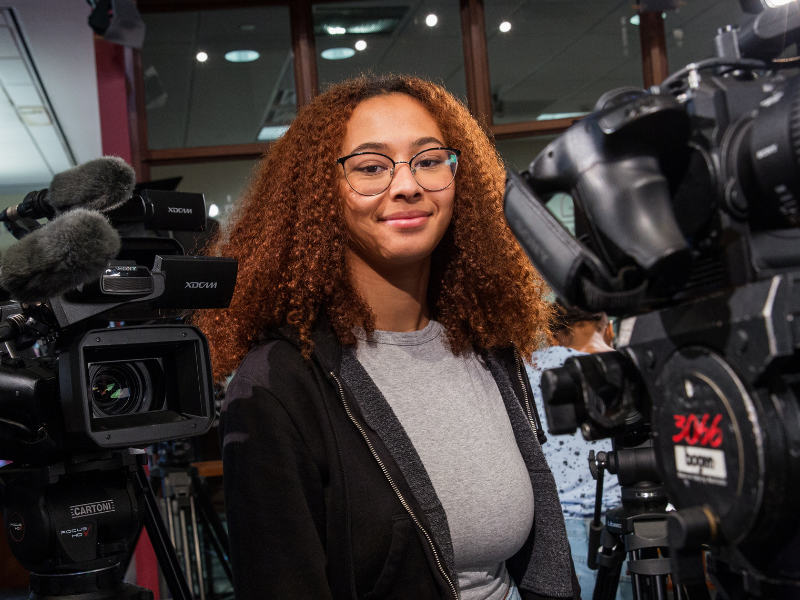 Gaylord Student surrounded by cameras