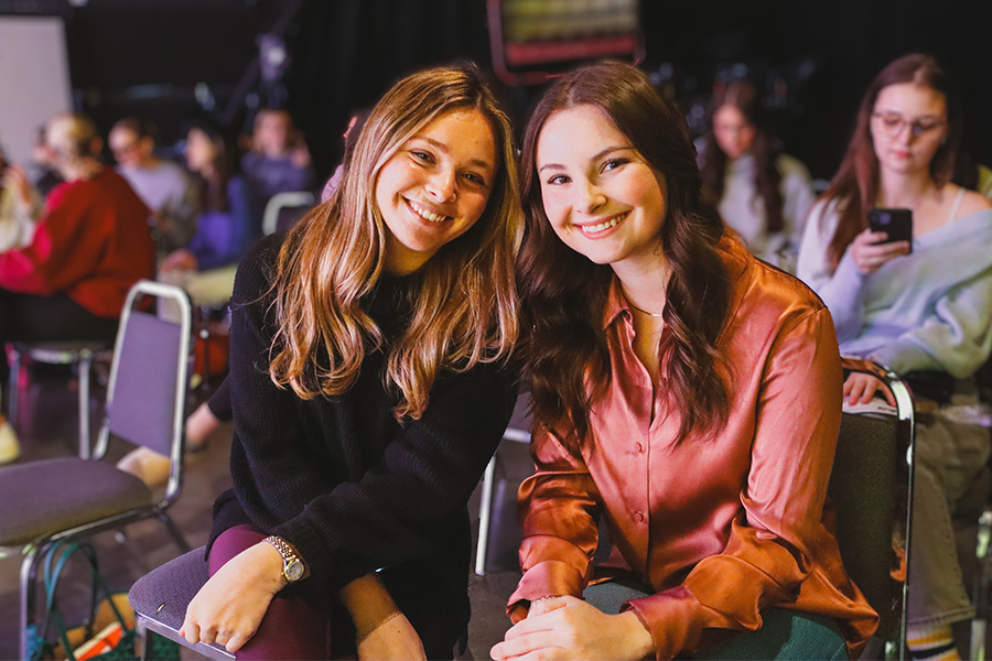 Five graduates in caps and gowns after Gaylord Convocation Ceremony.