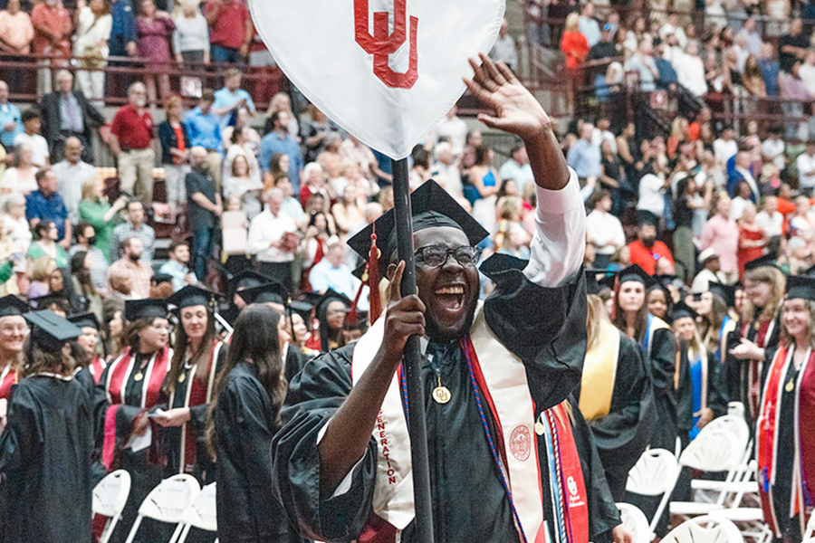 Graduate waving to family and friends during Gaylord Convocation ceremony