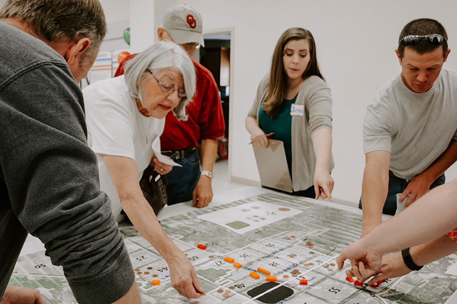 People gathered around a map on a table.