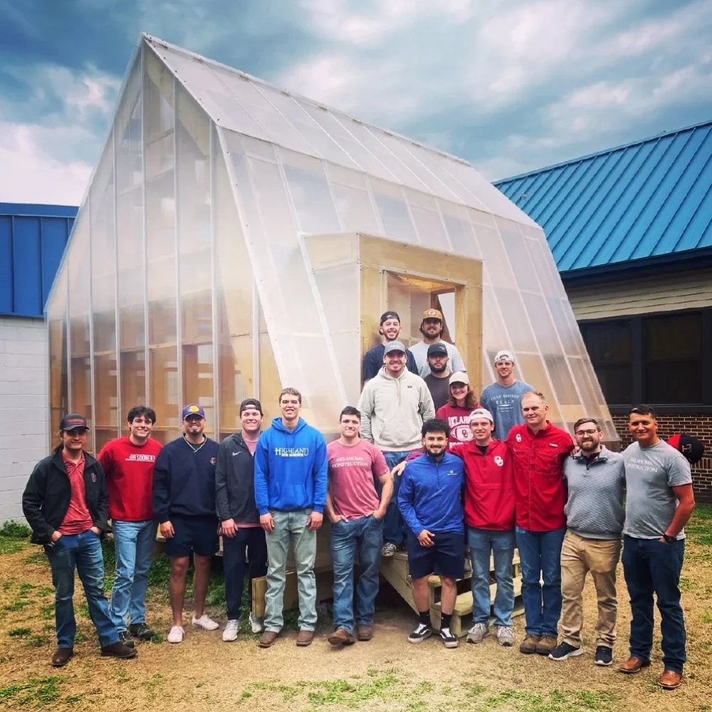 People standing in front of the Crutcho Greenhouse Classroom.