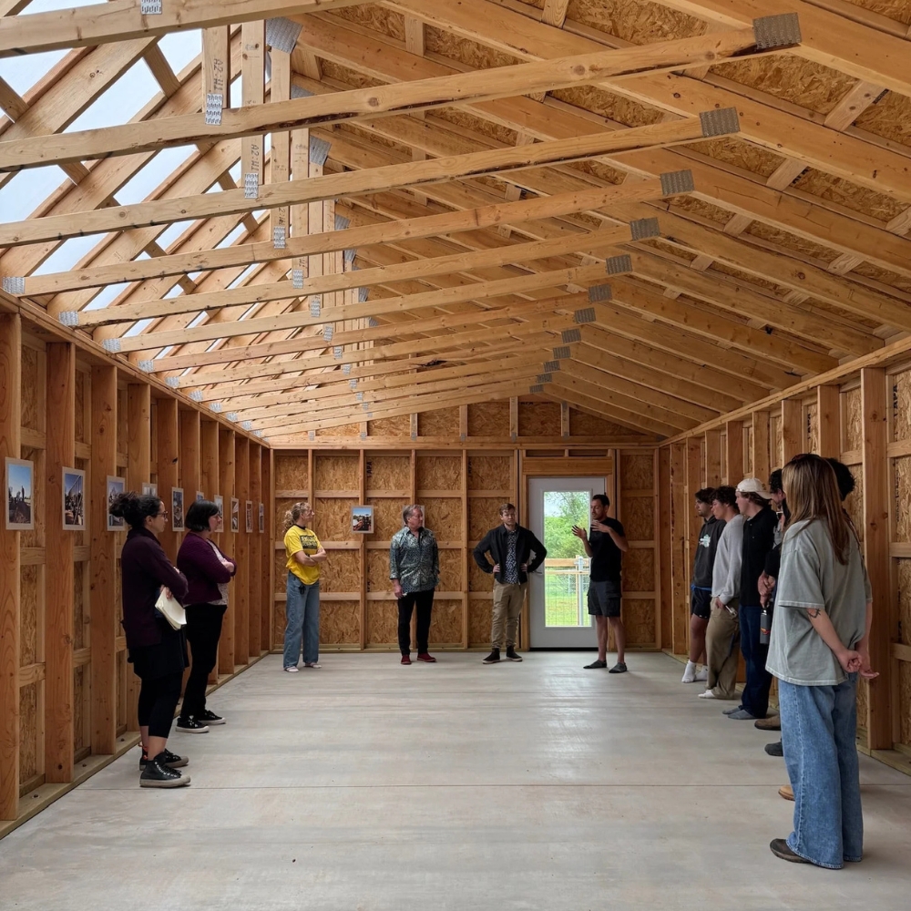 People standing in the interior of the Sunhive Collective Community Space.