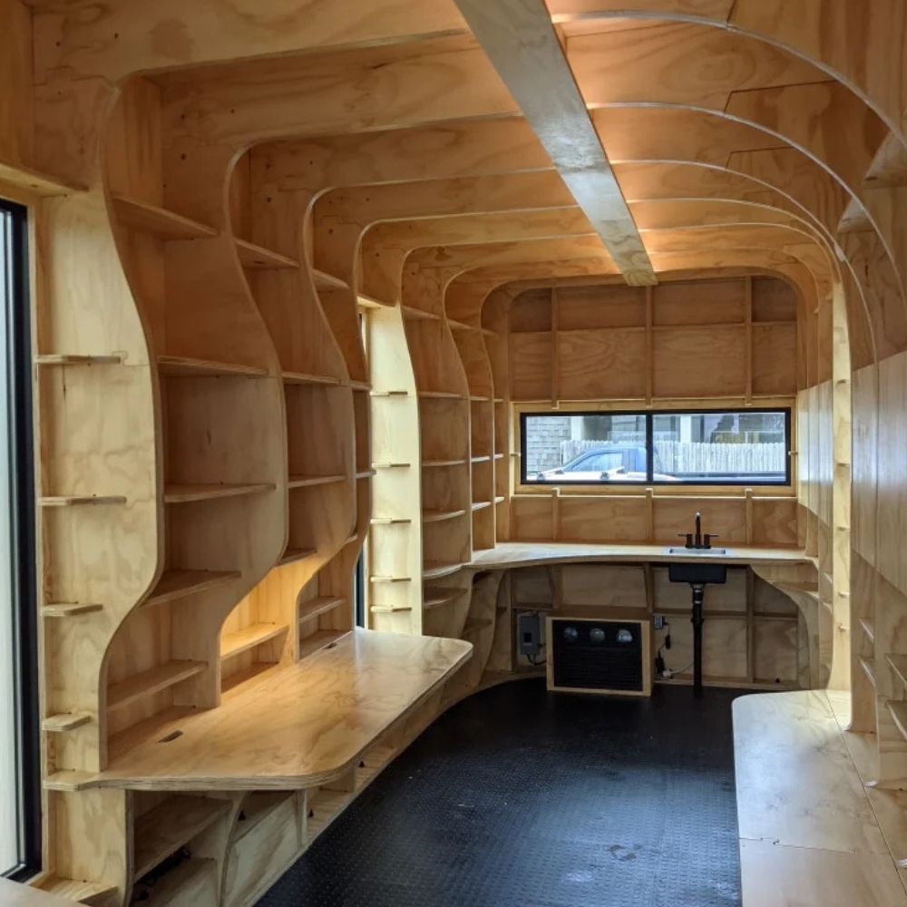 The interior of a mobile medical unit, featuring wood shelving and paneling.