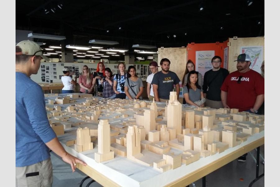O U students view a cityscape model.