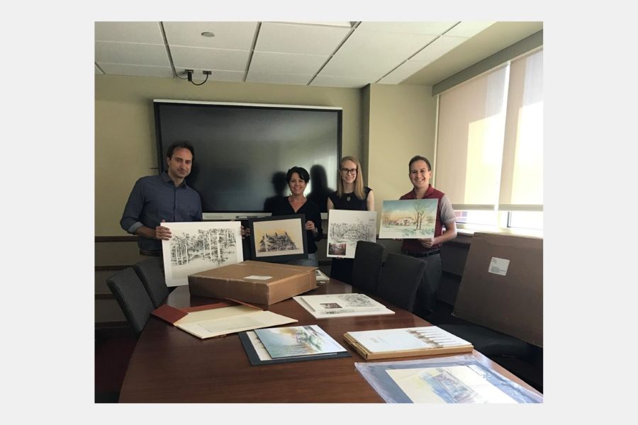 Members of the American School team displaying items from the collection.