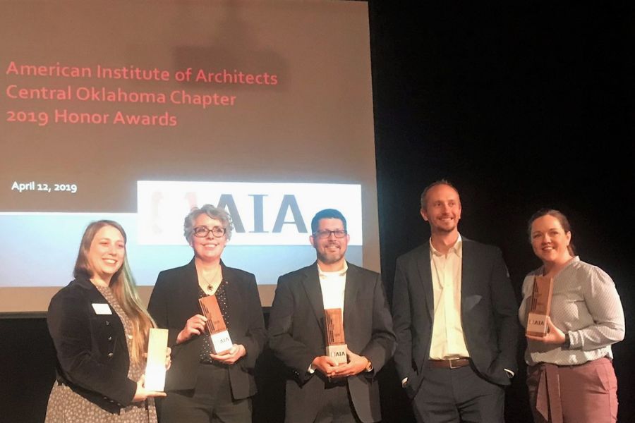 G C A alumni on stage accepting A I A Central Oklahoma honor awards. 