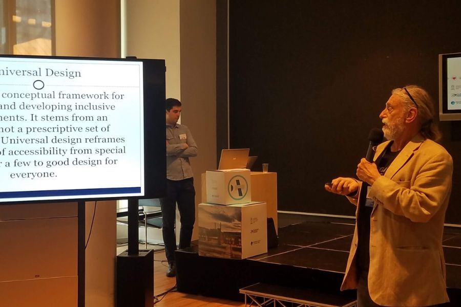 Professor David Boeck presenting at conference with slide that defines the term "universal design".