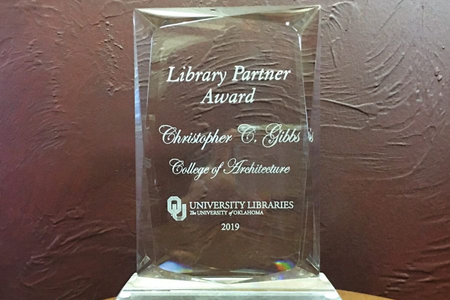 picture of partner award, clear crystal award with engraved lettering "Library Partner Award, Christopher C Gibbs, College of Architecture, O U university libraries logo, 2019".