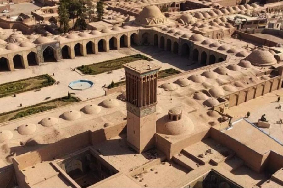 Aerial view of courtyard with domed roofs, arches, and central tower