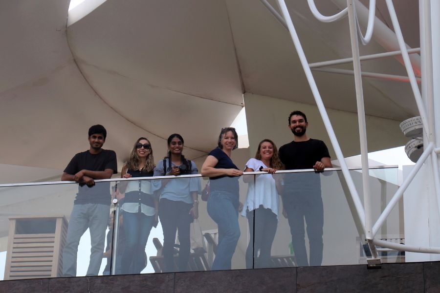 Students posing for a picture under an awning at The Gathering Place