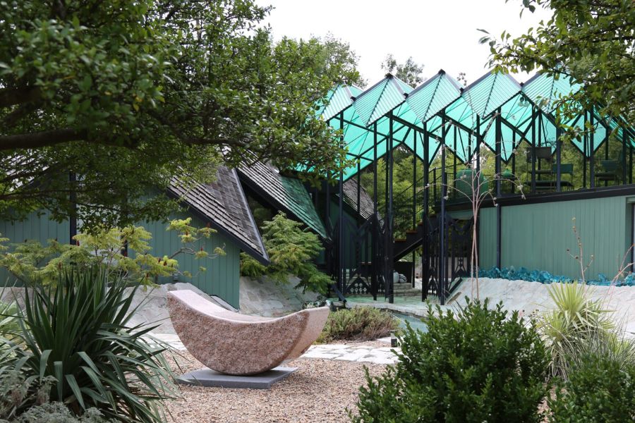 Photo of a rocky courtyard amidst modern, american school architecture including green glass