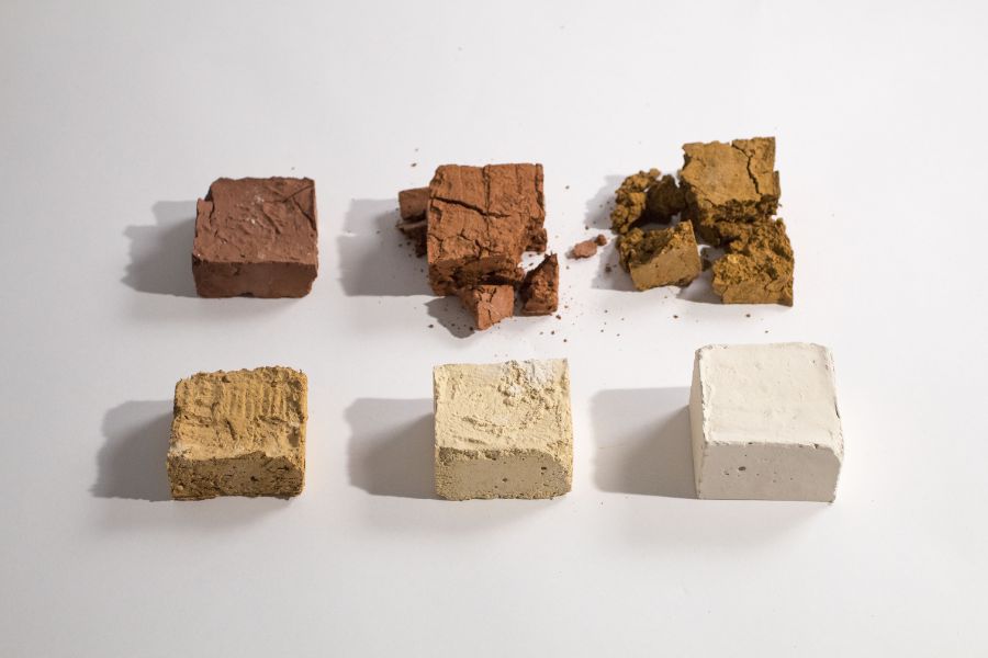 Material samples of different colors in various states of completeness on a white table