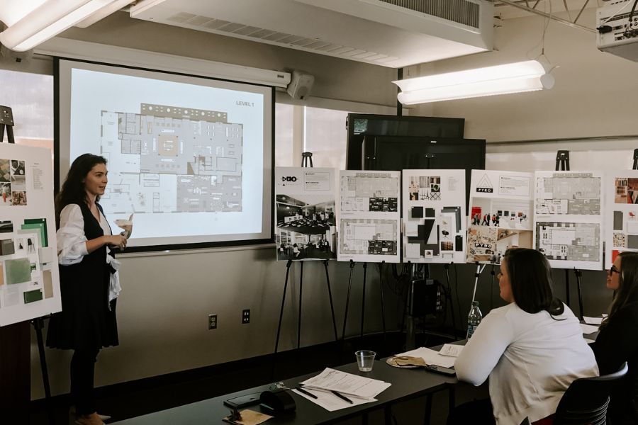 Someone giving a presentation in an interior design classroom
