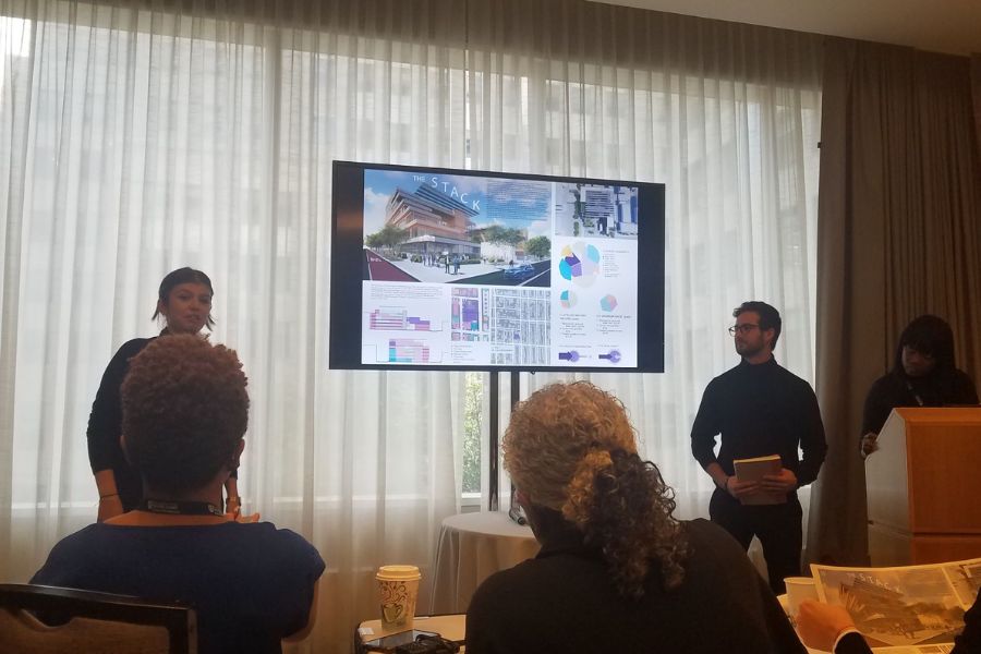 Students presenting in front of a TV