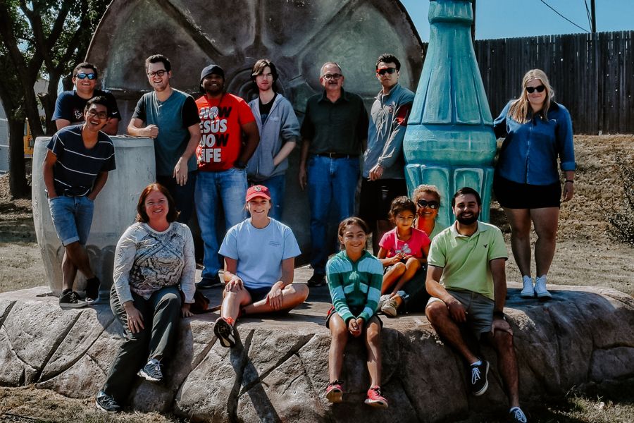 a group of environmental design studnets posing for a picture on a rock